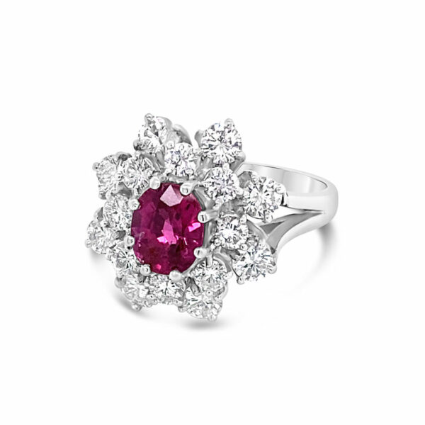 a pink and white ring with diamonds around it