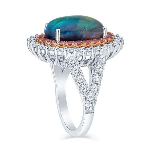 a ring with an oval black opal surrounded by diamonds