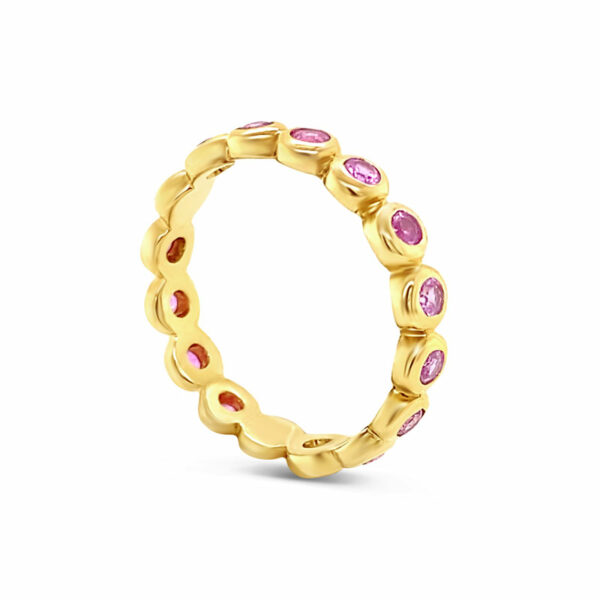 a yellow gold ring with pink stones