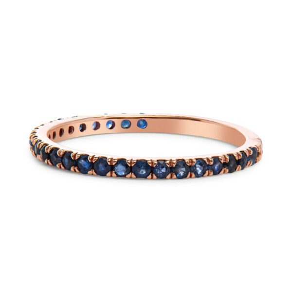 a rose gold band with blue sapphire stones