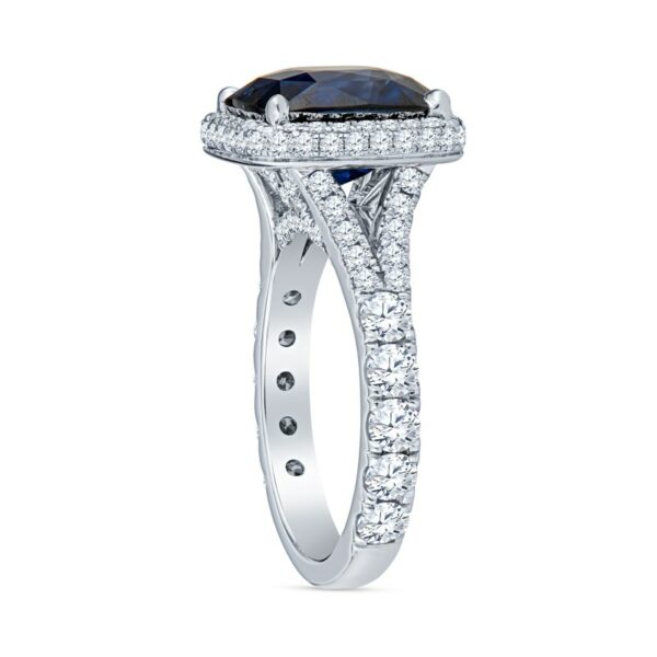 a white gold ring with an oval shaped blue sapphire surrounded by diamonds