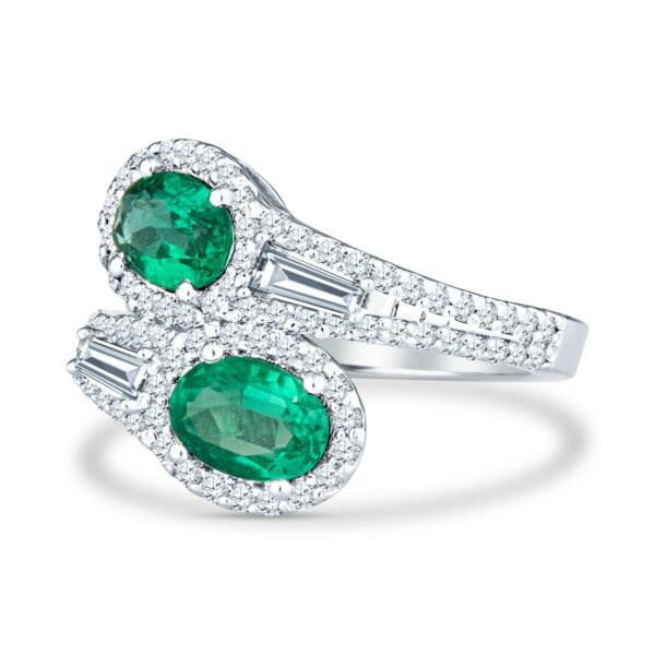 two emerald and diamond rings on a white background