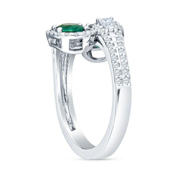 a ring with an emerald and diamonds on it