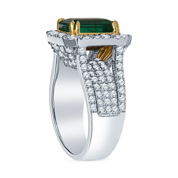 a ring with an emerald and diamonds on it