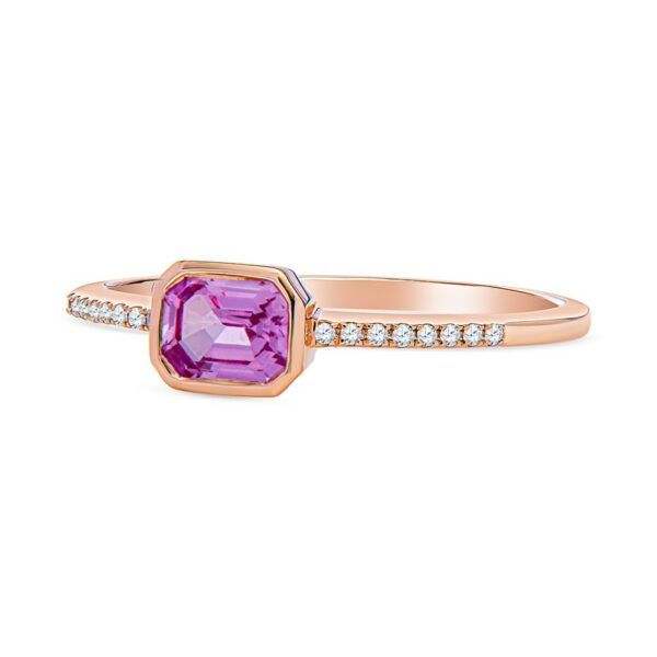 a pink sapphire and diamond ring on a white background