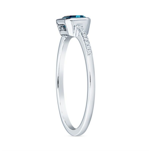 a white gold ring with an aqua topazte and diamonds
