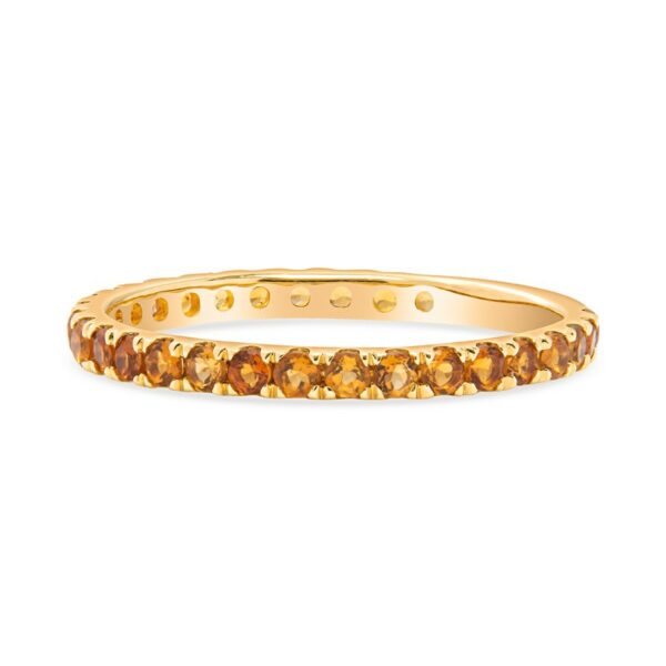 a yellow gold ring with orange stones