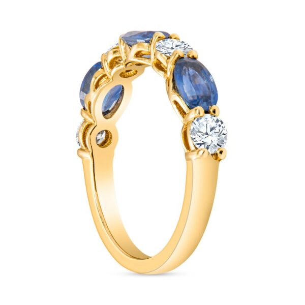 a yellow gold ring with blue sapphires and diamonds