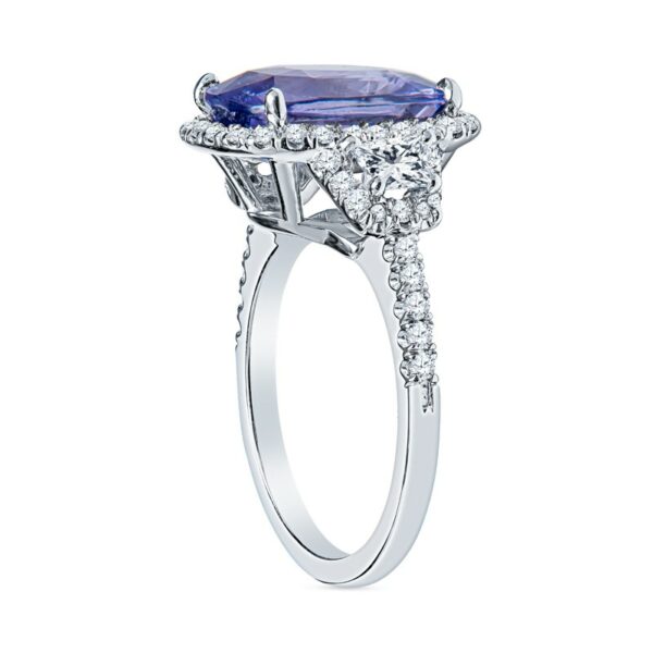 a ring with an oval shaped tanzante surrounded by diamonds