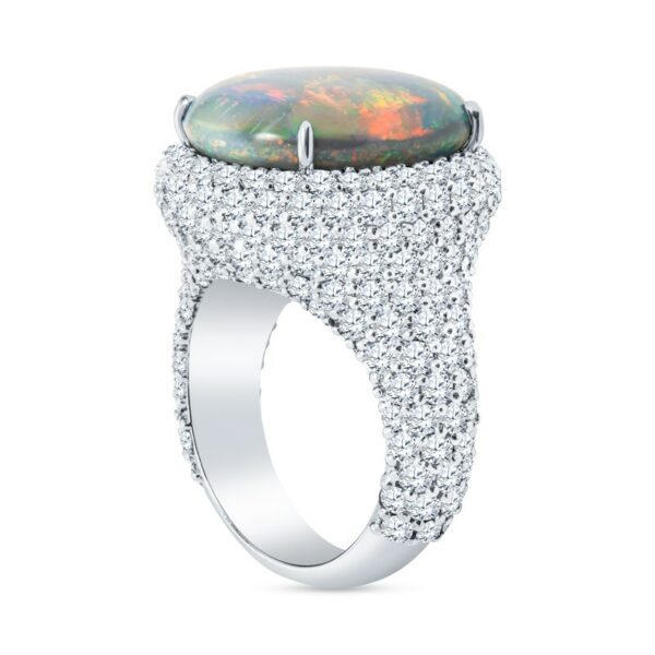 a ring with an opal surrounded by diamonds