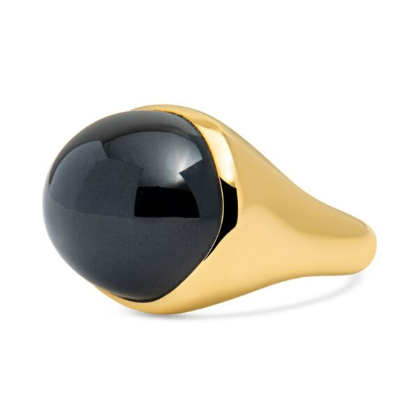 a black and gold signet ring on a white background