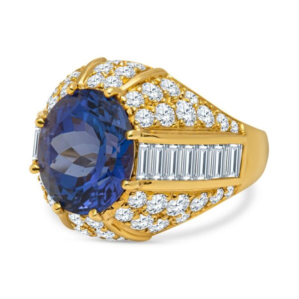 a tan gold ring with an oval blue sapphire surrounded by baguettes