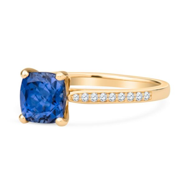 a yellow gold ring with a blue sapphire and diamonds