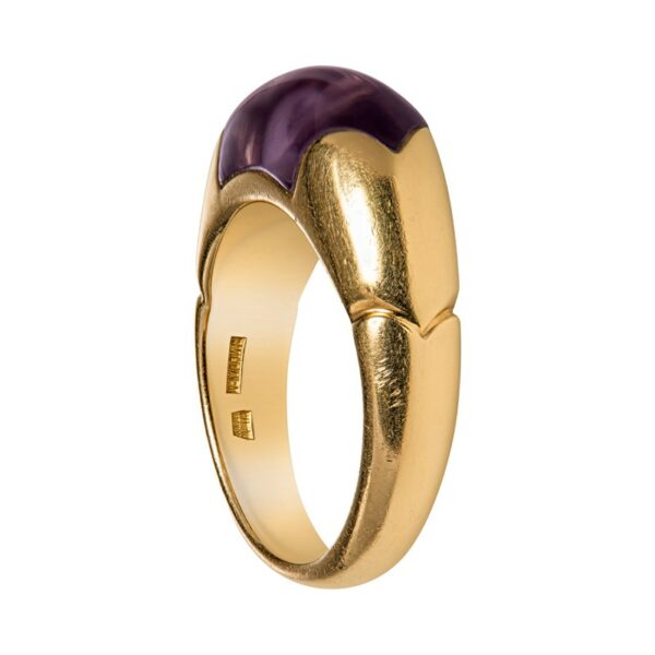 a gold ring with a purple stone in the center
