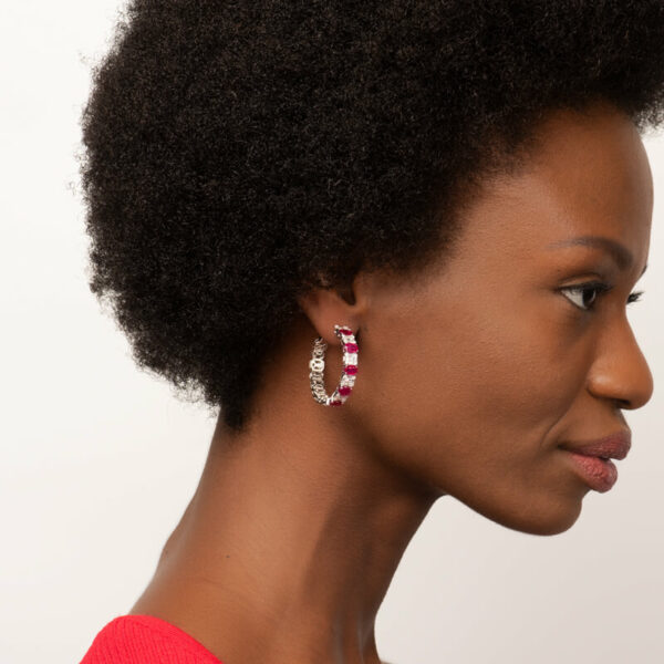 a woman with an afro is wearing earrings