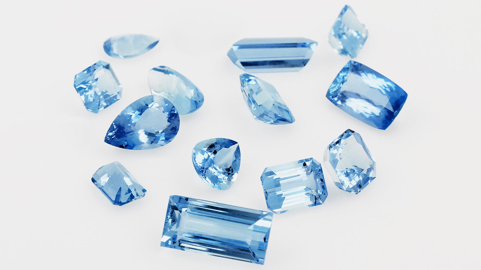 several blue diamonds are scattered on a white surface