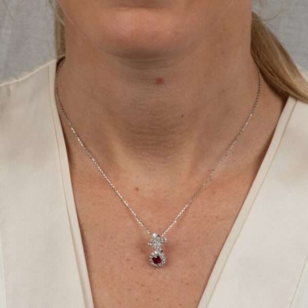 a woman wearing a diamond and ruby necklace