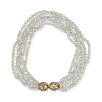 a white beaded necklace with two gold - tone beads