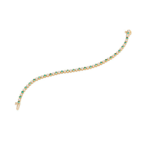 a gold bracelet with green beads and a diamond clasp