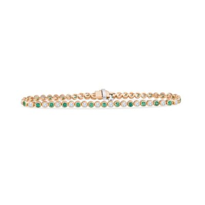 a gold bracelet with green and white stones