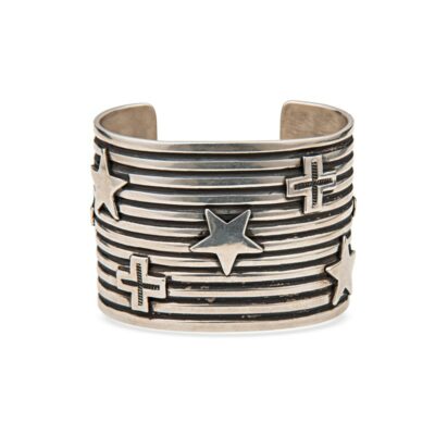 a silver cuff with stars and crosses on it