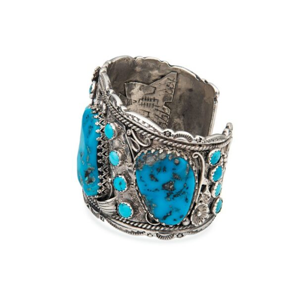 a silver bracelet with turquoise stones on it