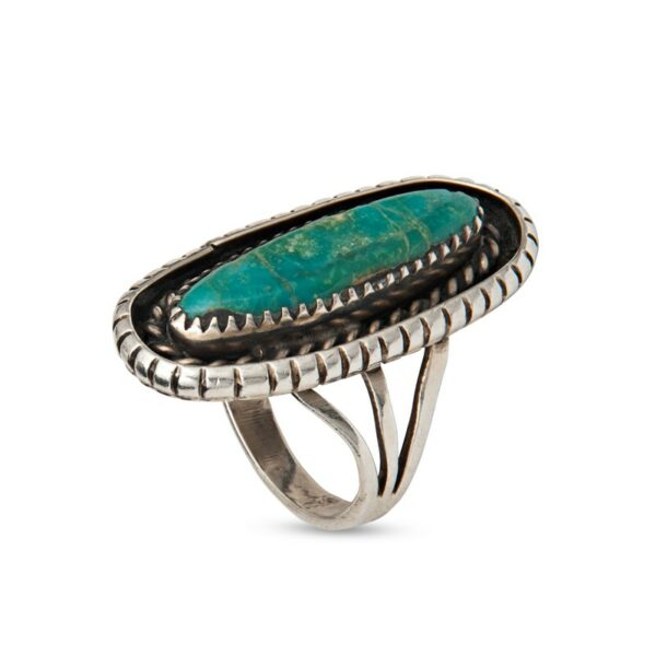 a silver ring with a green stone in it