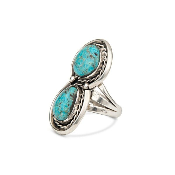 a silver ring with two turquoise stones on it