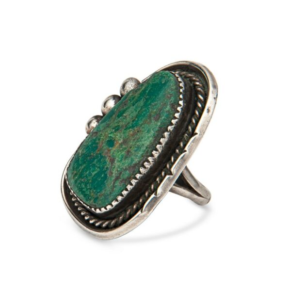 a ring with a green stone in it