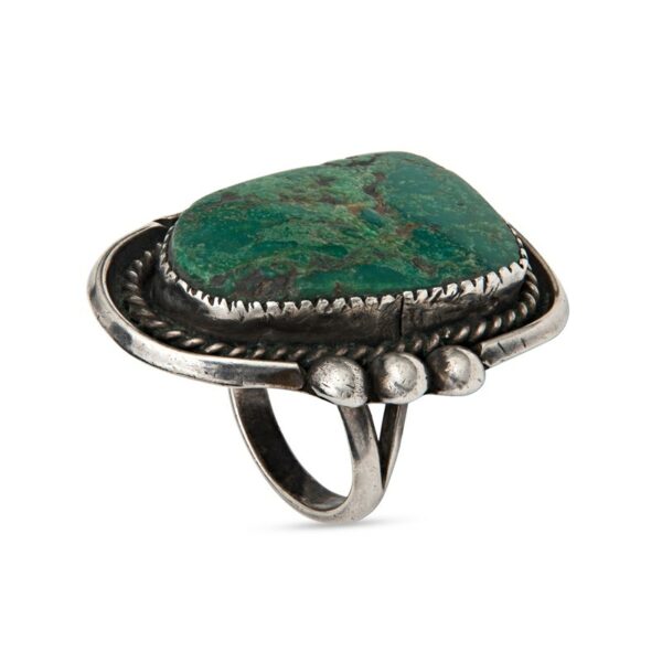 a ring with a green stone on it