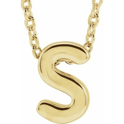 a gold necklace with the letter s on it
