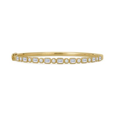 a yellow gold bang bracelet with diamonds