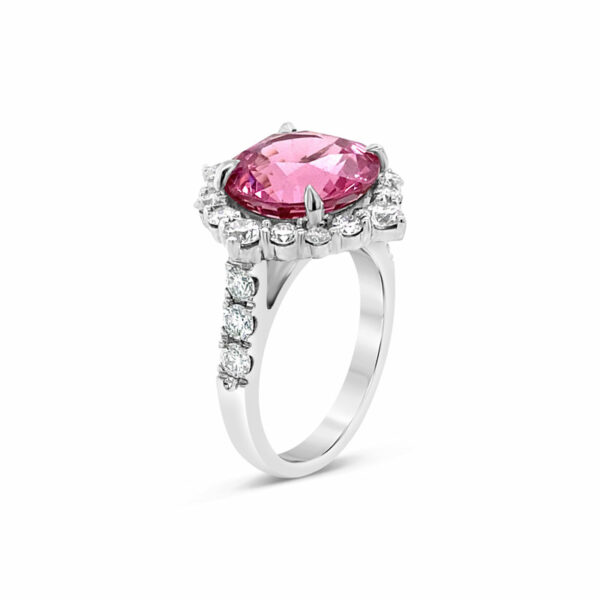 a pink diamond ring with diamonds around it