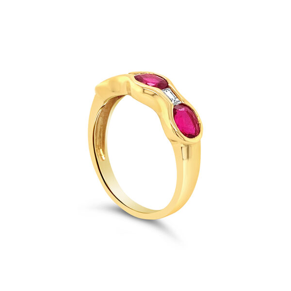 a yellow gold ring with two ruby stones