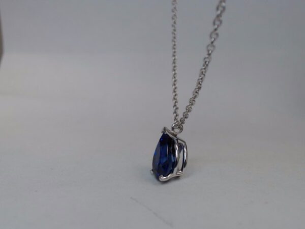 a necklace with a blue stone hanging from it