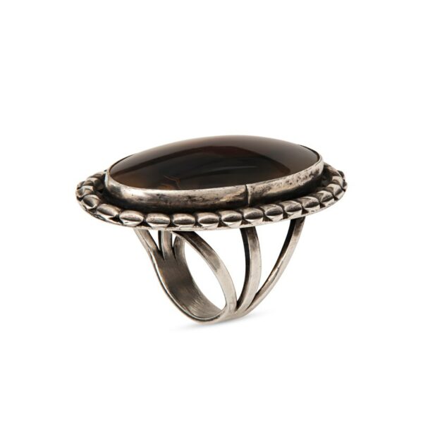 a silver ring with a brown stone on it