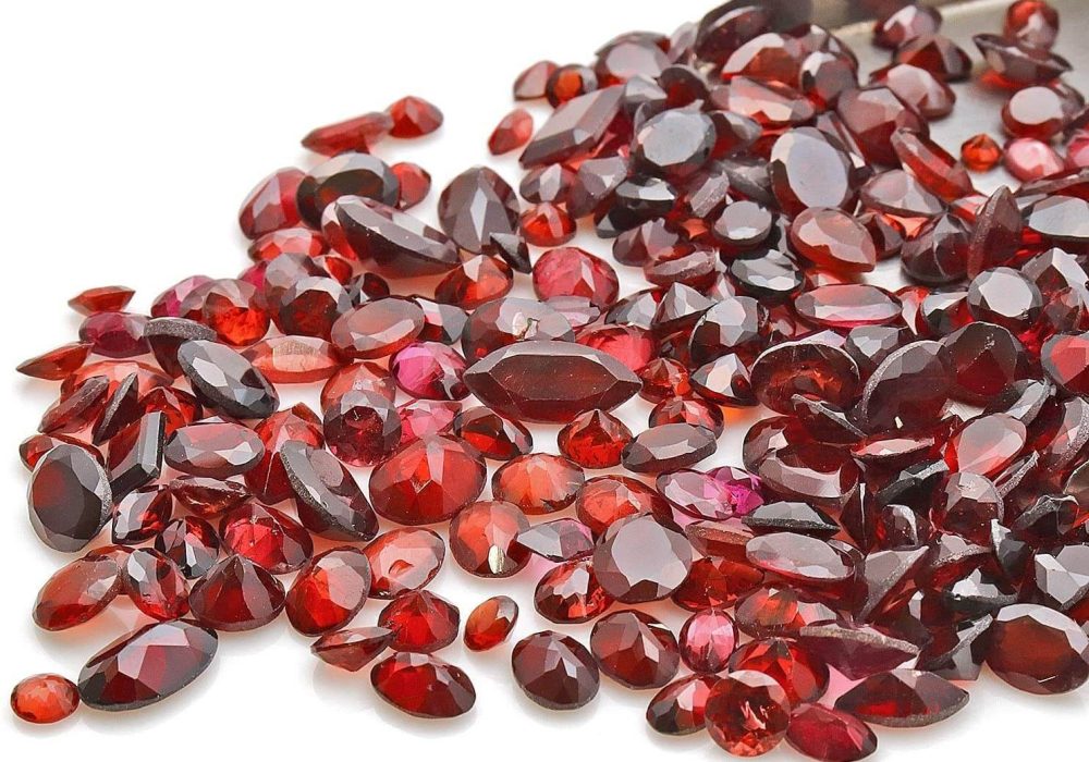 a pile of red stones sitting on top of a white table